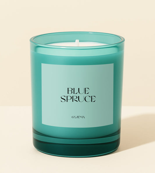 Teal candle with 'Blue Spruce' label on a beige background
