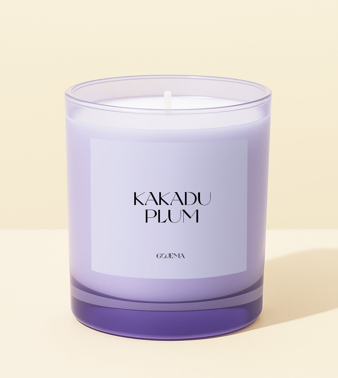 Purple candle labeled 'Kakadu Plum' by Gojema on a light beige background