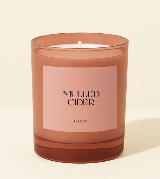 Candle with 'Mulled Cider' label on a beige background